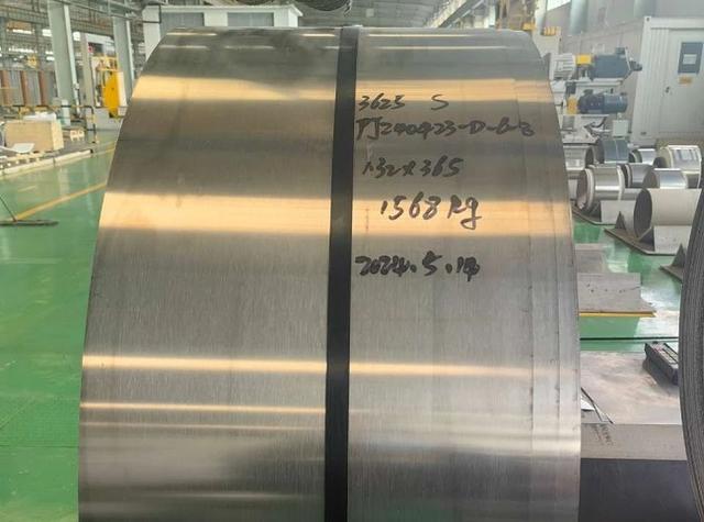 Person standing in a factory with machinery in the background