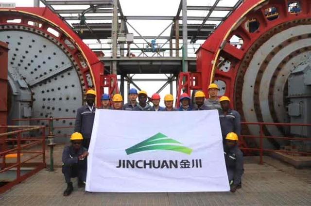 Person standing in a factory with machinery in the background